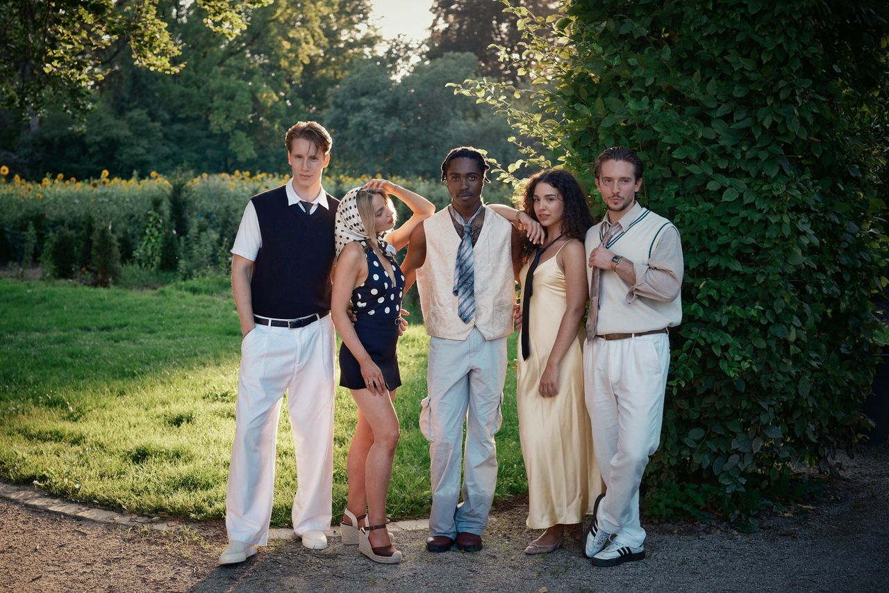 services-03 Five stylish young adults posing in a summer park, exuding modern fashion and confidence.