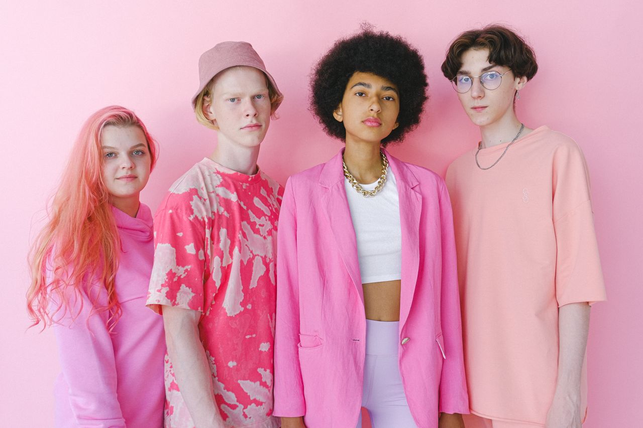 services-04 Diverse teenage friends in trendy outfits looking at camera on pink background of studio